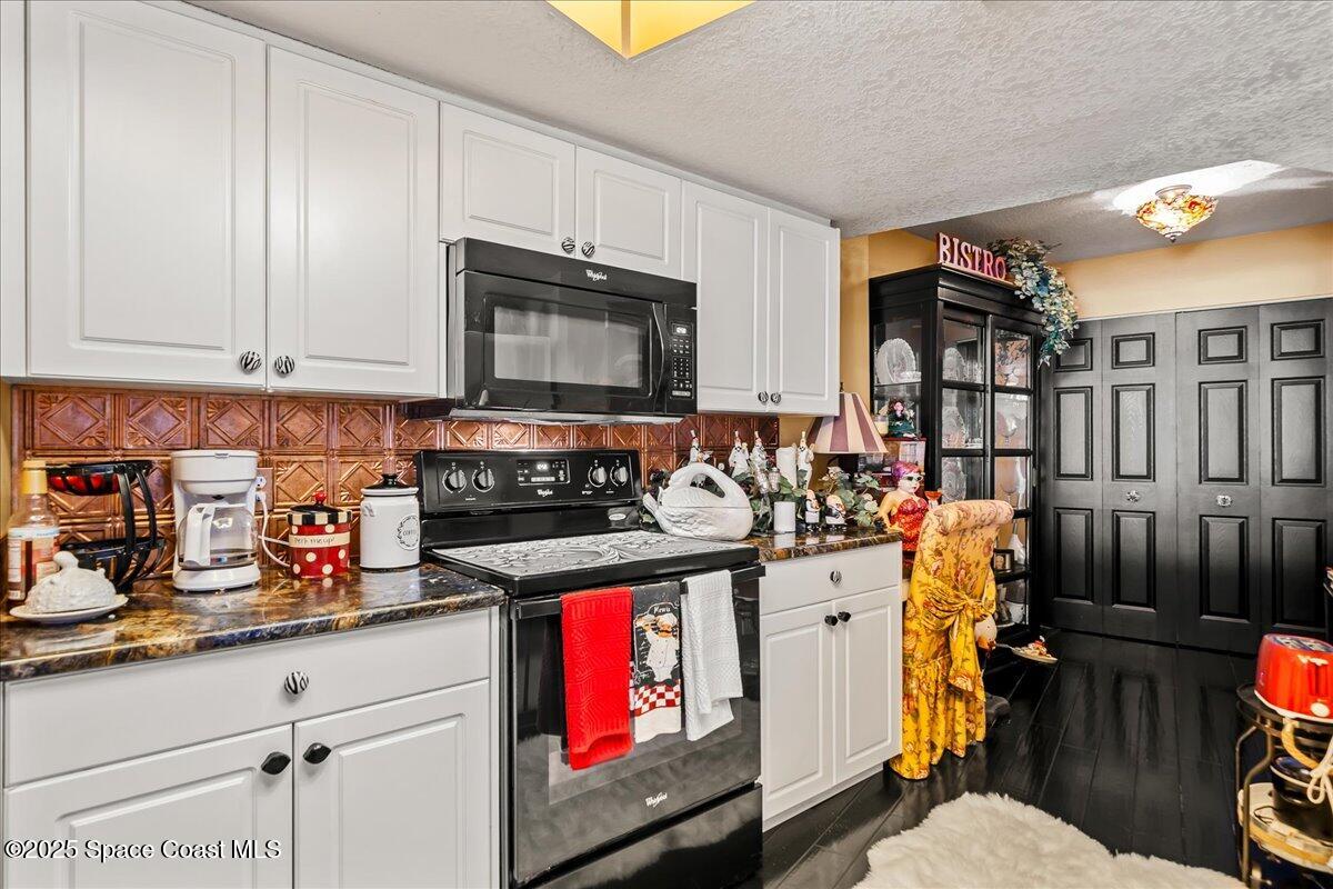104 Riverside Drive, Unit 203 Cocoa, FL 32922 - Photo 18 of 48 a kitchen with stainless steel appliances granite countertop a stove and cabinets