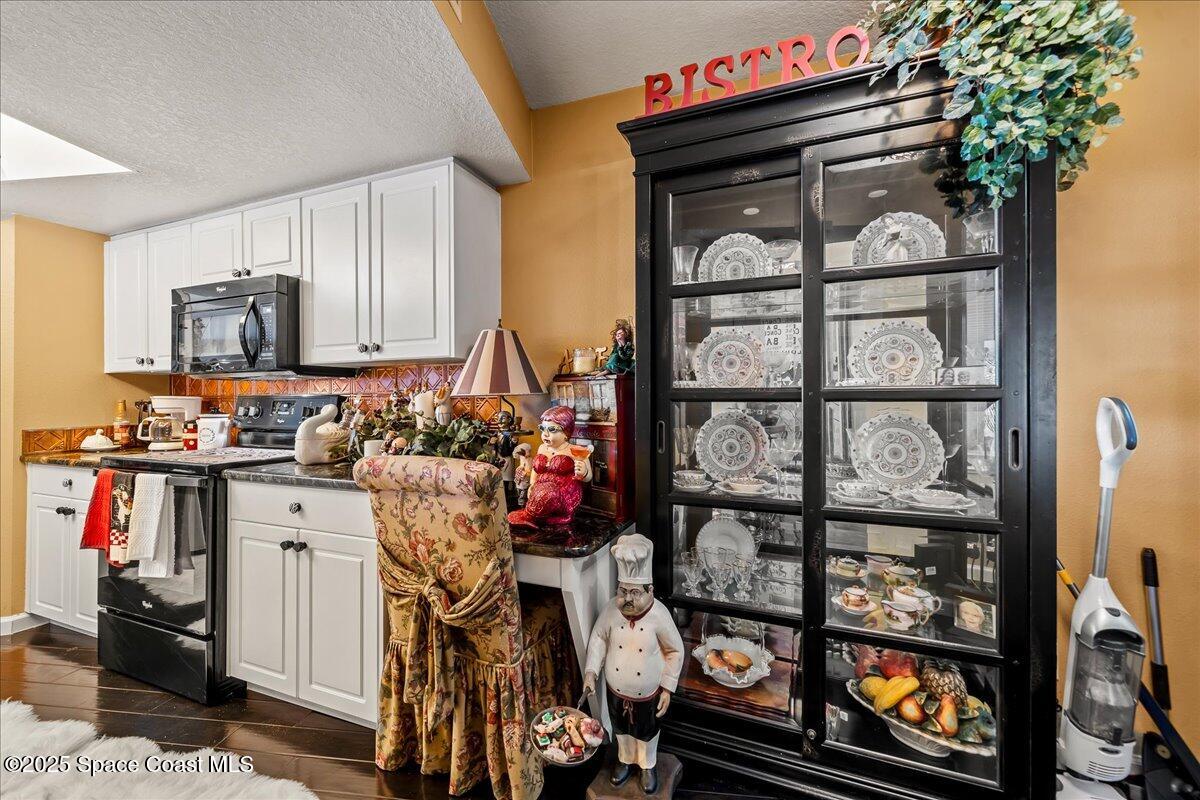 104 Riverside Drive, Unit 203 Cocoa, FL 32922 - Photo 19 of 48 a kitchen with stainless steel appliances granite countertop a refrigerator and a stove