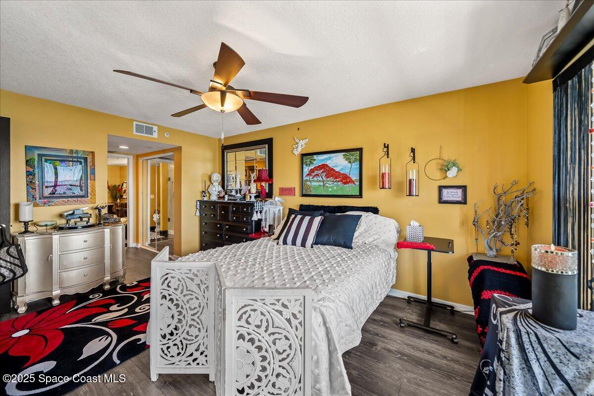 104 Riverside Drive, Unit 203 Cocoa, FL 32922 - Photo 27 of 48 a living room with furniture a flat screen tv and a floor to ceiling window