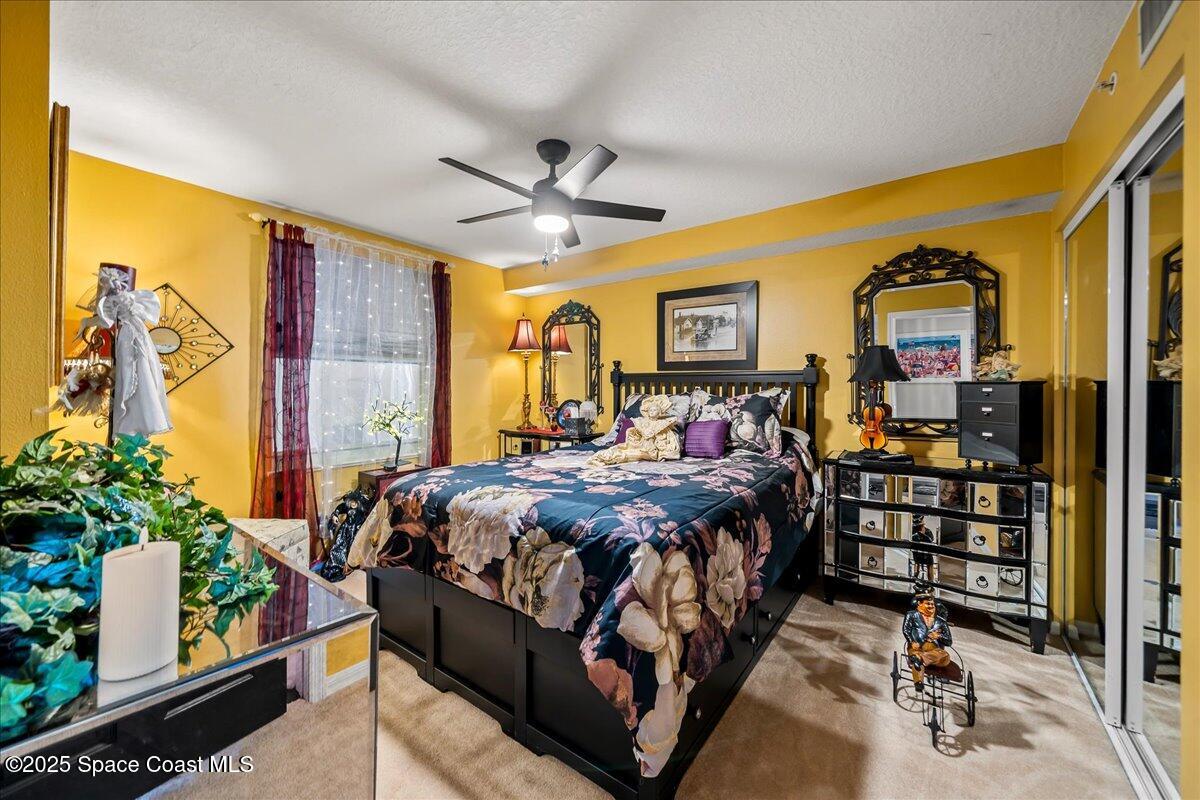 104 Riverside Drive, Unit 203 Cocoa, FL 32922 - Photo 28 of 48 a bed sitting in a bedroom next to a window