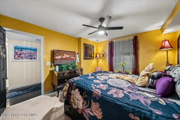 a bedroom with bed and a mirror