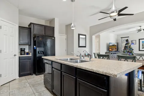 a kitchen with a sink a refrigerator and cabinets