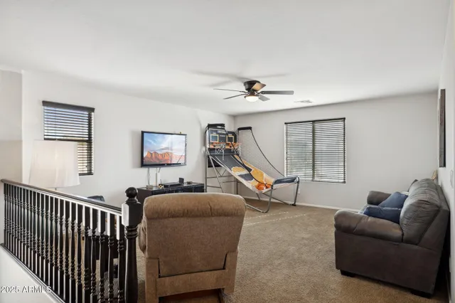 a living room with furniture a window and a wooden floor