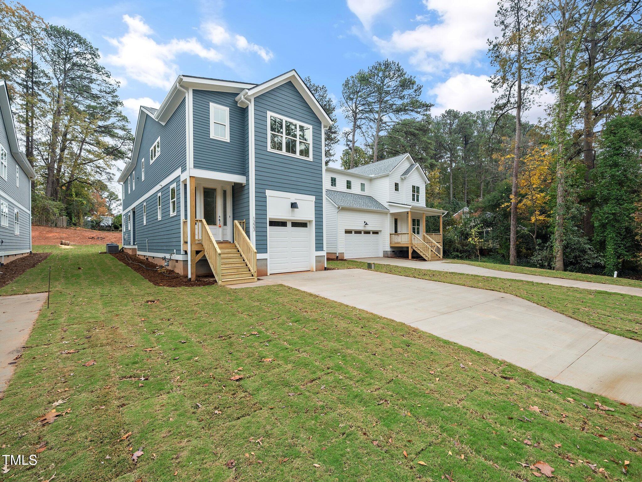 1223 Chaney Road Raleigh, NC 27606 - Photo 1 of 25 a front view of a house with a yard