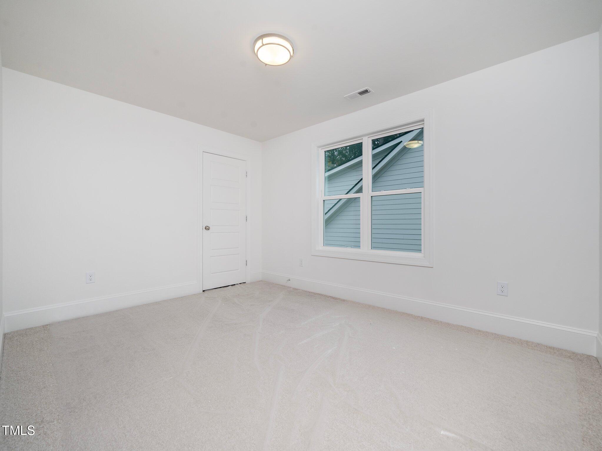 1223 Chaney Road Raleigh, NC 27606 - Photo 15 of 25 an empty room with a window