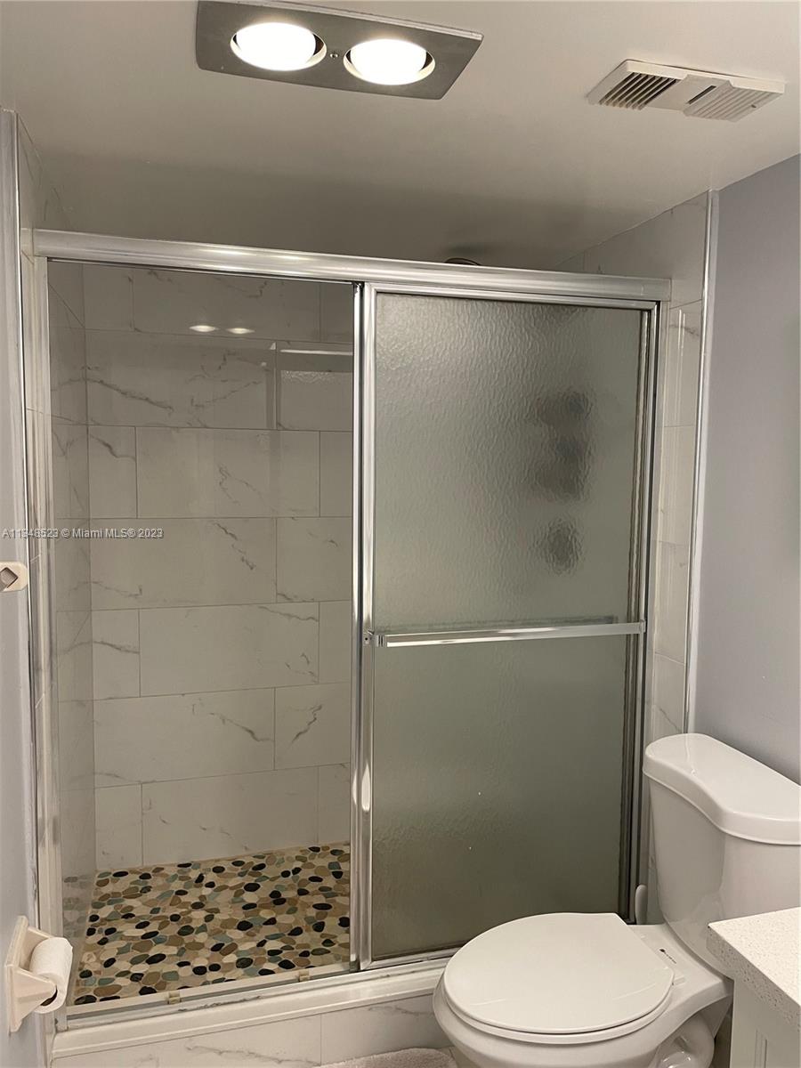 23370 Carolwood Lane, Unit 2202 Boca Raton, FL 33428 - Photo 11 of 31 a bathroom with a toilet and a shower