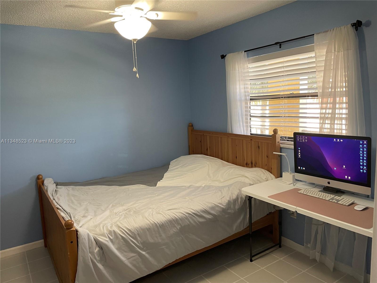 23370 Carolwood Lane, Unit 2202 Boca Raton, FL 33428 - Photo 14 of 31 a bedroom with a bed table and window
