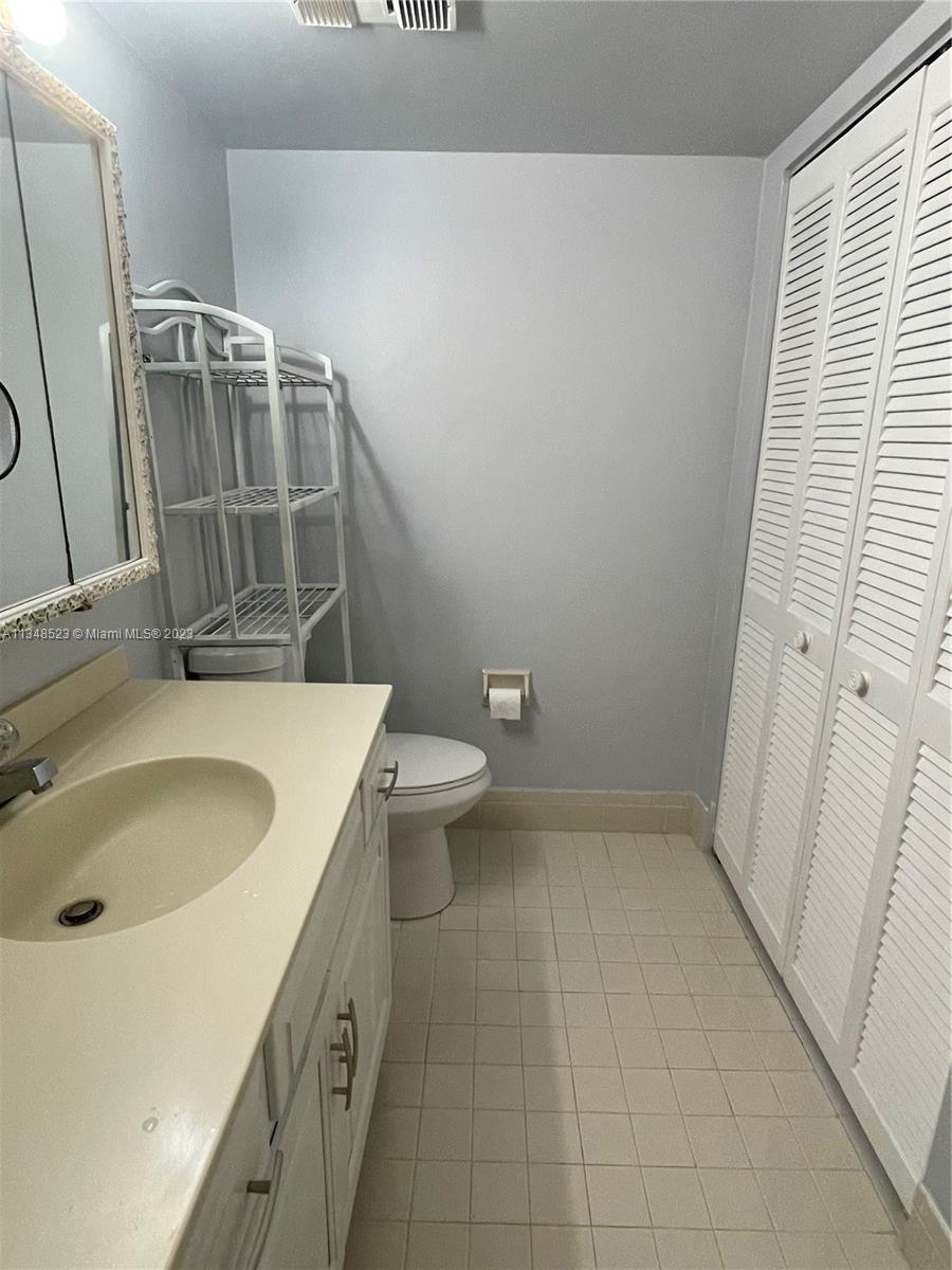23370 Carolwood Lane, Unit 2202 Boca Raton, FL 33428 - Photo 17 of 31 a bathroom with a sink a toilet and shower
