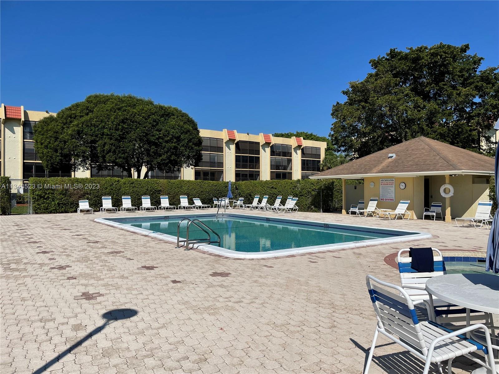 23370 Carolwood Lane, Unit 2202 Boca Raton, FL 33428 - Photo 21 of 31 a front view of a house with garden
