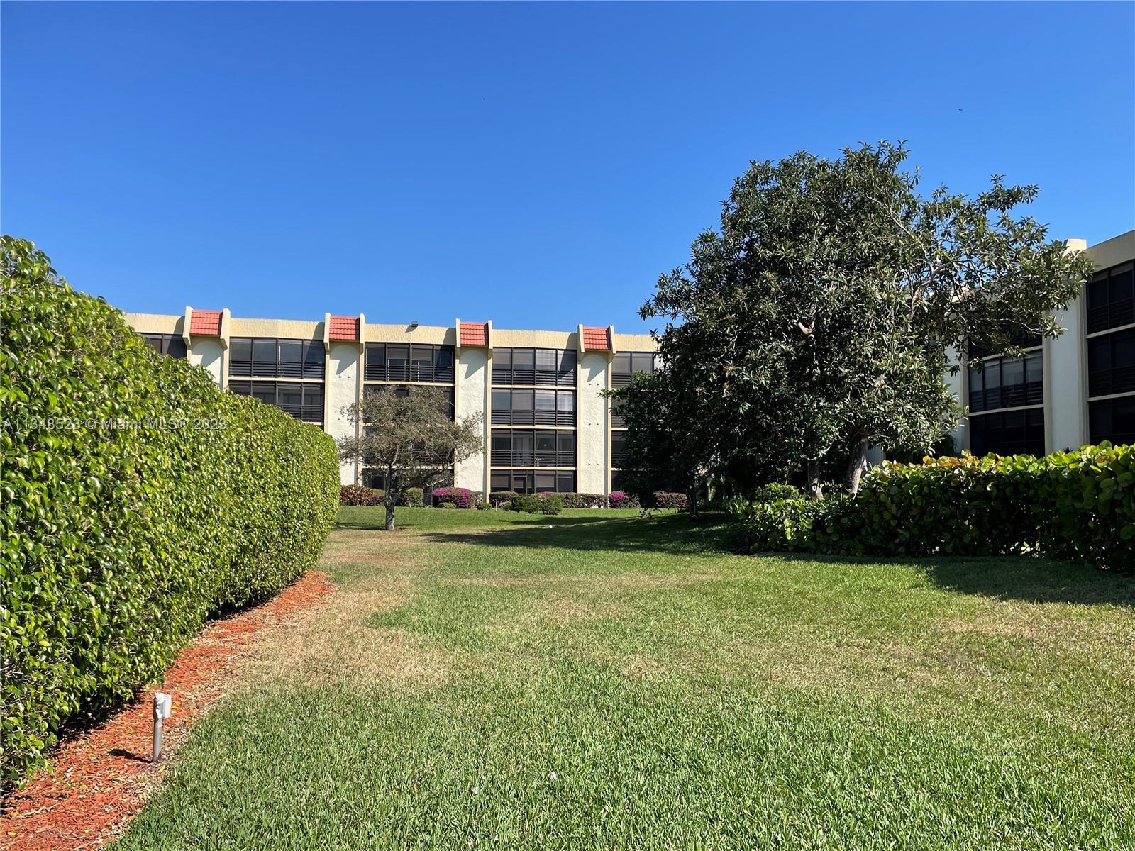 23370 Carolwood Lane, Unit 2202 Boca Raton, FL 33428 - Photo 28 of 31 a view of a building with garden
