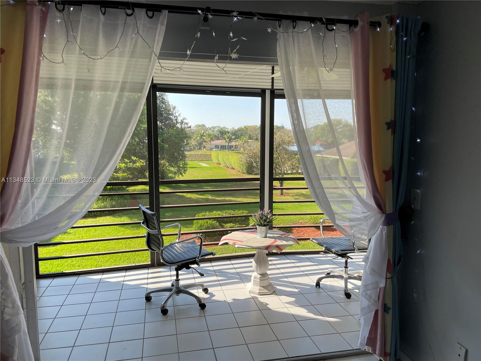 23370 Carolwood Lane, Unit 2202 Boca Raton, FL 33428 - Photo 3 of 31 a view of a living room with a floor to ceiling window and stairs