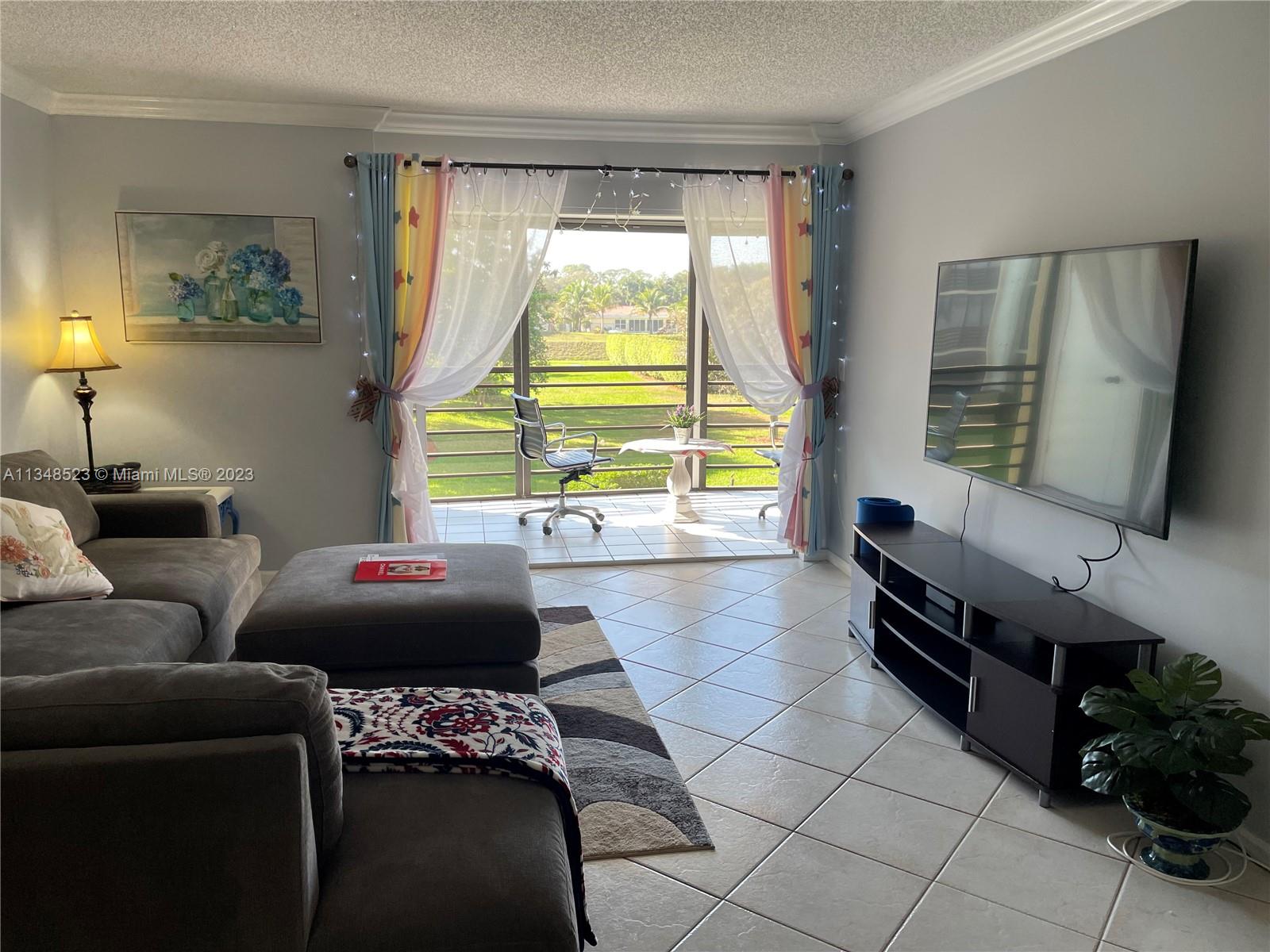 23370 Carolwood Lane, Unit 2202 Boca Raton, FL 33428 - Photo 4 of 31 a living room with furniture and a window