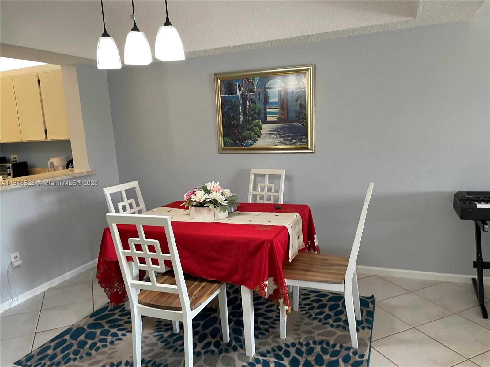 23370 Carolwood Lane, Unit 2202 Boca Raton, FL 33428 - Photo 7 of 31 a dining room with furniture and chandelier