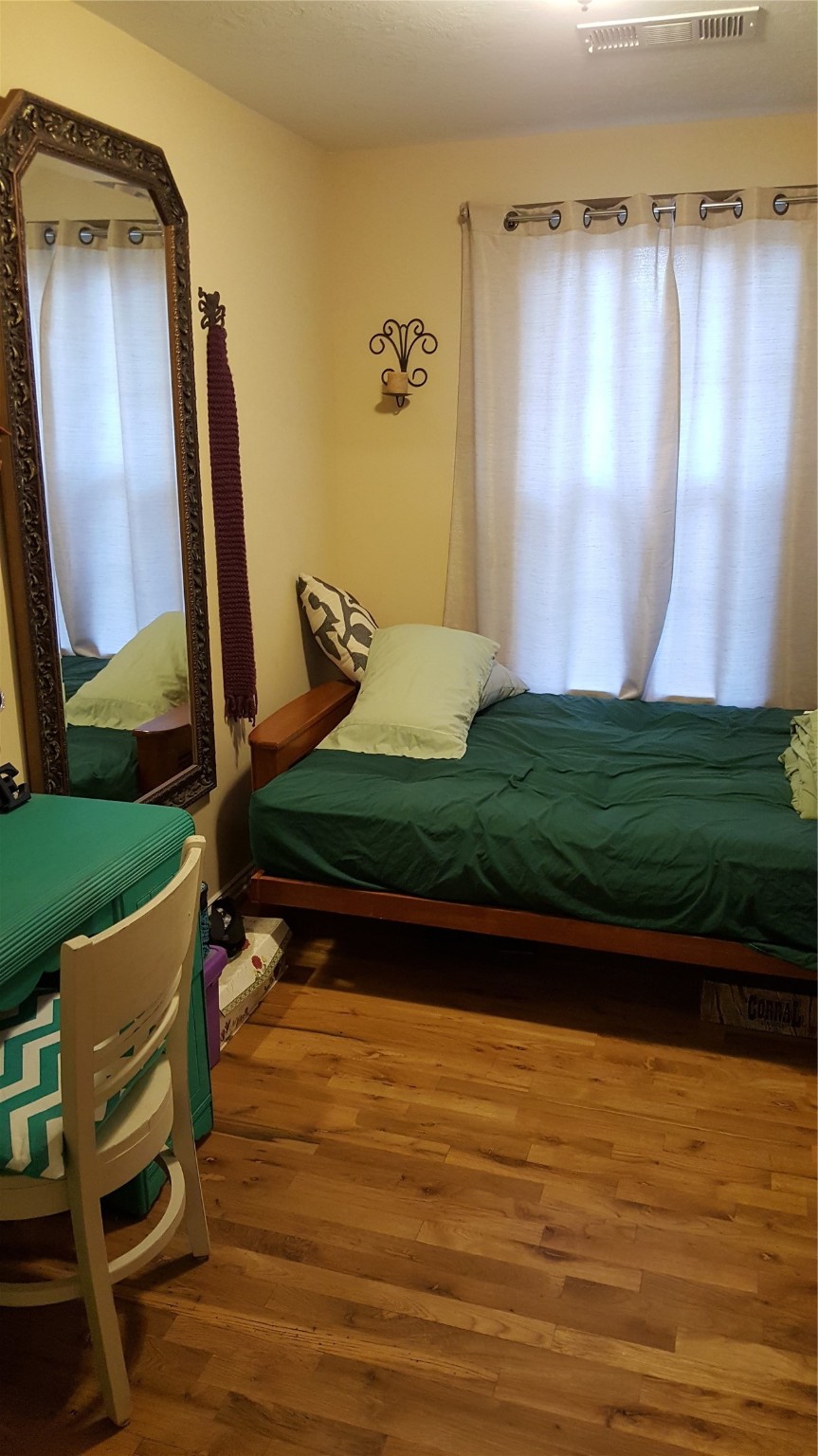 4615 Woodside Street Houston, TX 77023 - Photo 12 of 25 a view of room with stairs and wooden floor