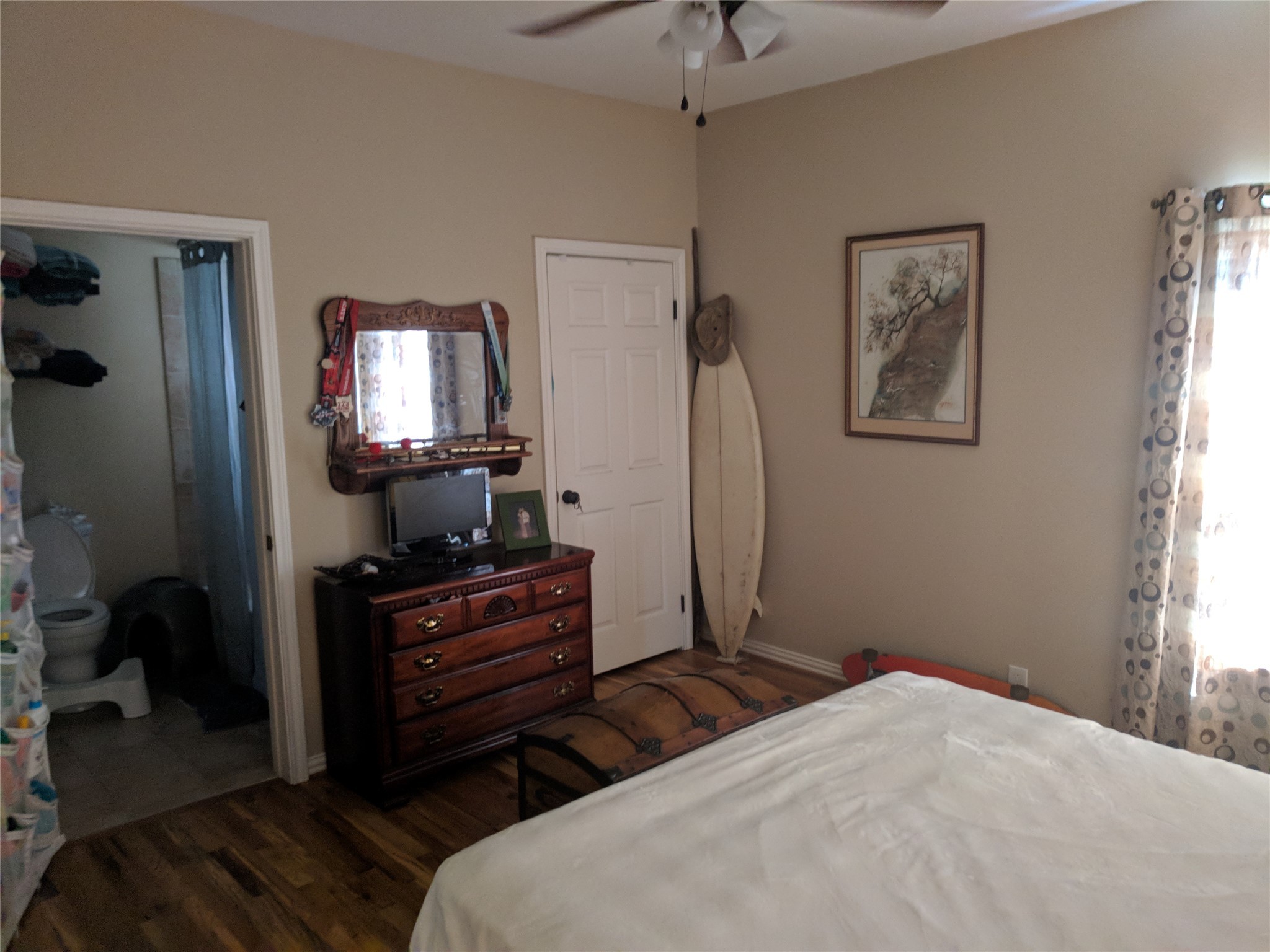 4615 Woodside Street Houston, TX 77023 - Photo 13 of 25 a bedroom with a bed and a flat tv screen on dresser