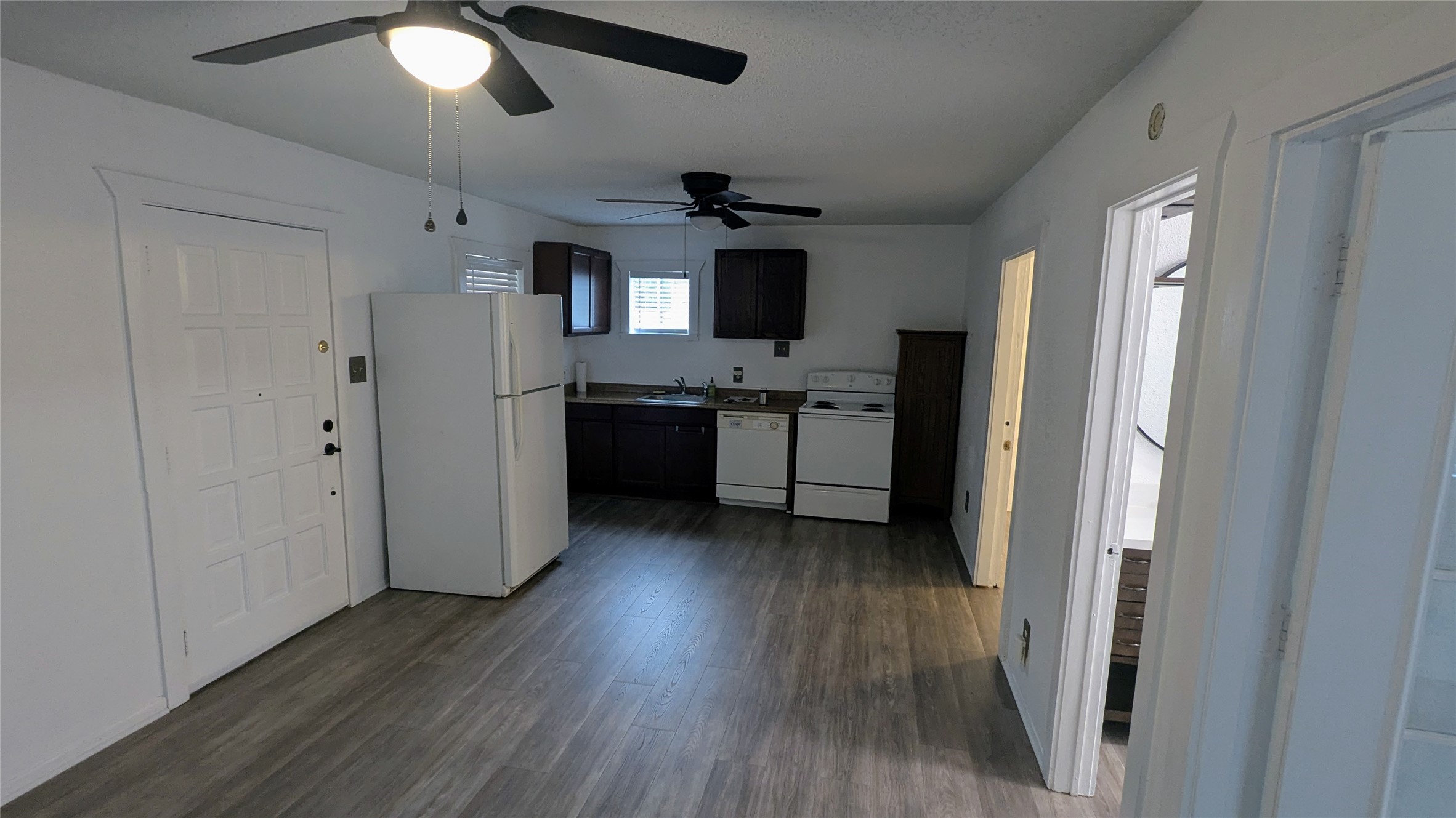 4615 Woodside Street Houston, TX 77023 - Photo 19 of 25 a view of a kitchen with a refrigerator and a stove top oven
