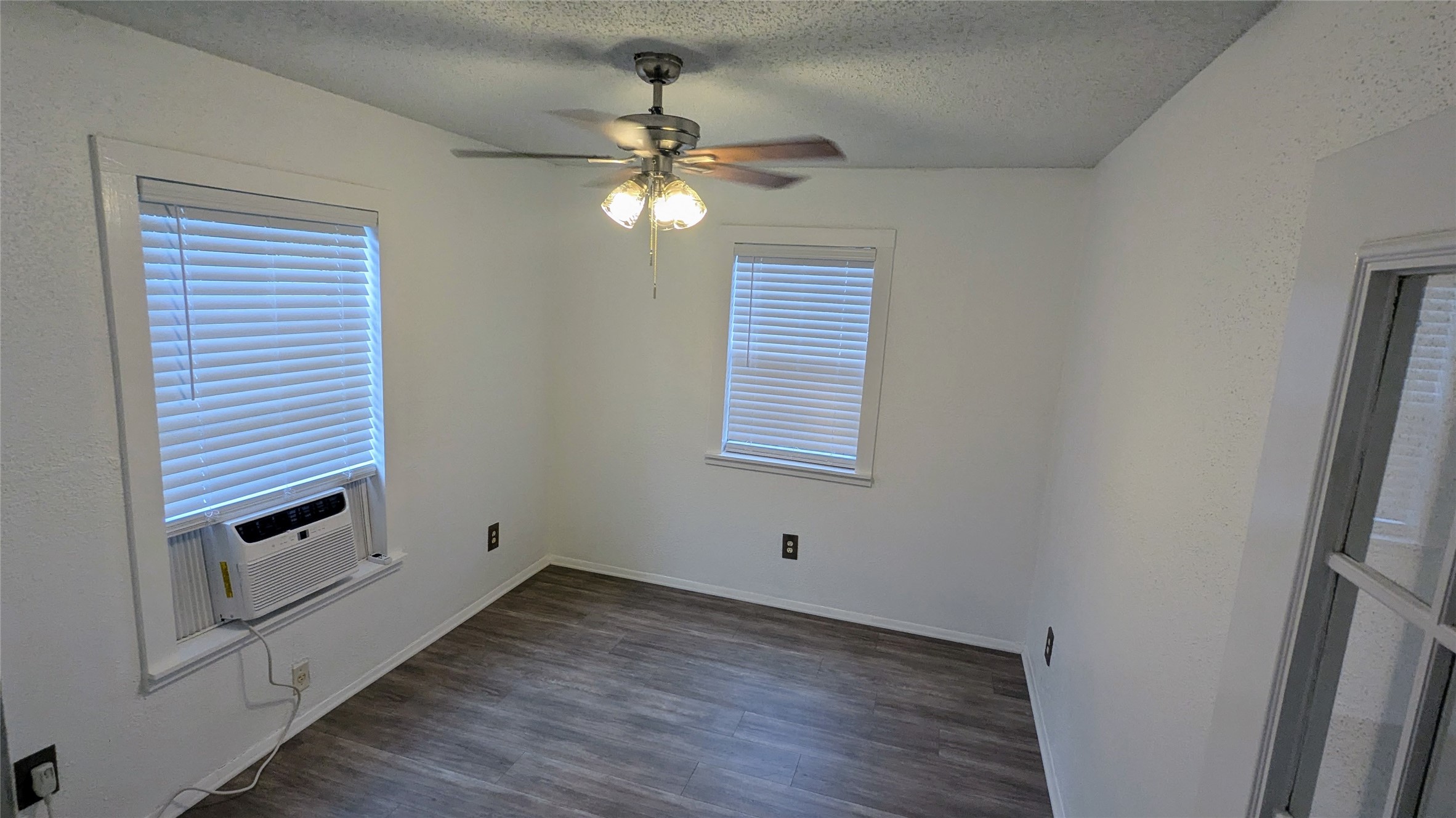 4615 Woodside Street Houston, TX 77023 - Photo 21 of 25 a view of empty room with wooden floor and fan