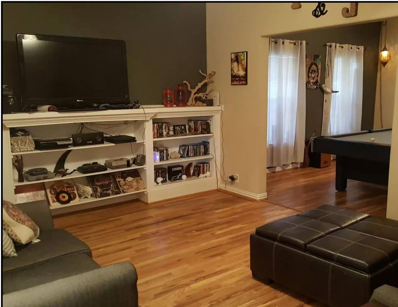 4615 Woodside Street Houston, TX 77023 - Photo 4 of 25 a living room with furniture and a flat screen tv