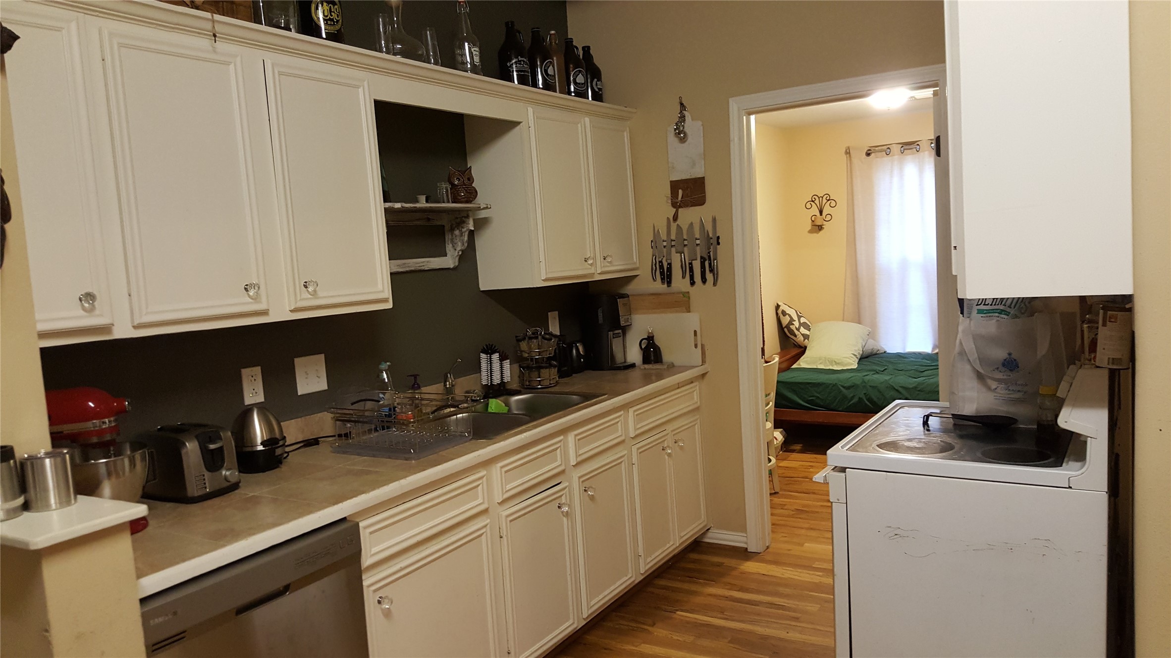 4615 Woodside Street Houston, TX 77023 - Photo 8 of 25 a kitchen with white cabinets and sink