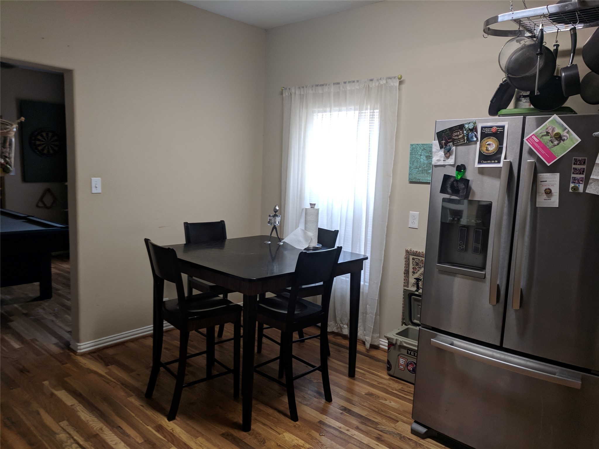 4615 Woodside Street Houston, TX 77023 - Photo 9 of 25 a kitchen with a refrigerator and table chairs