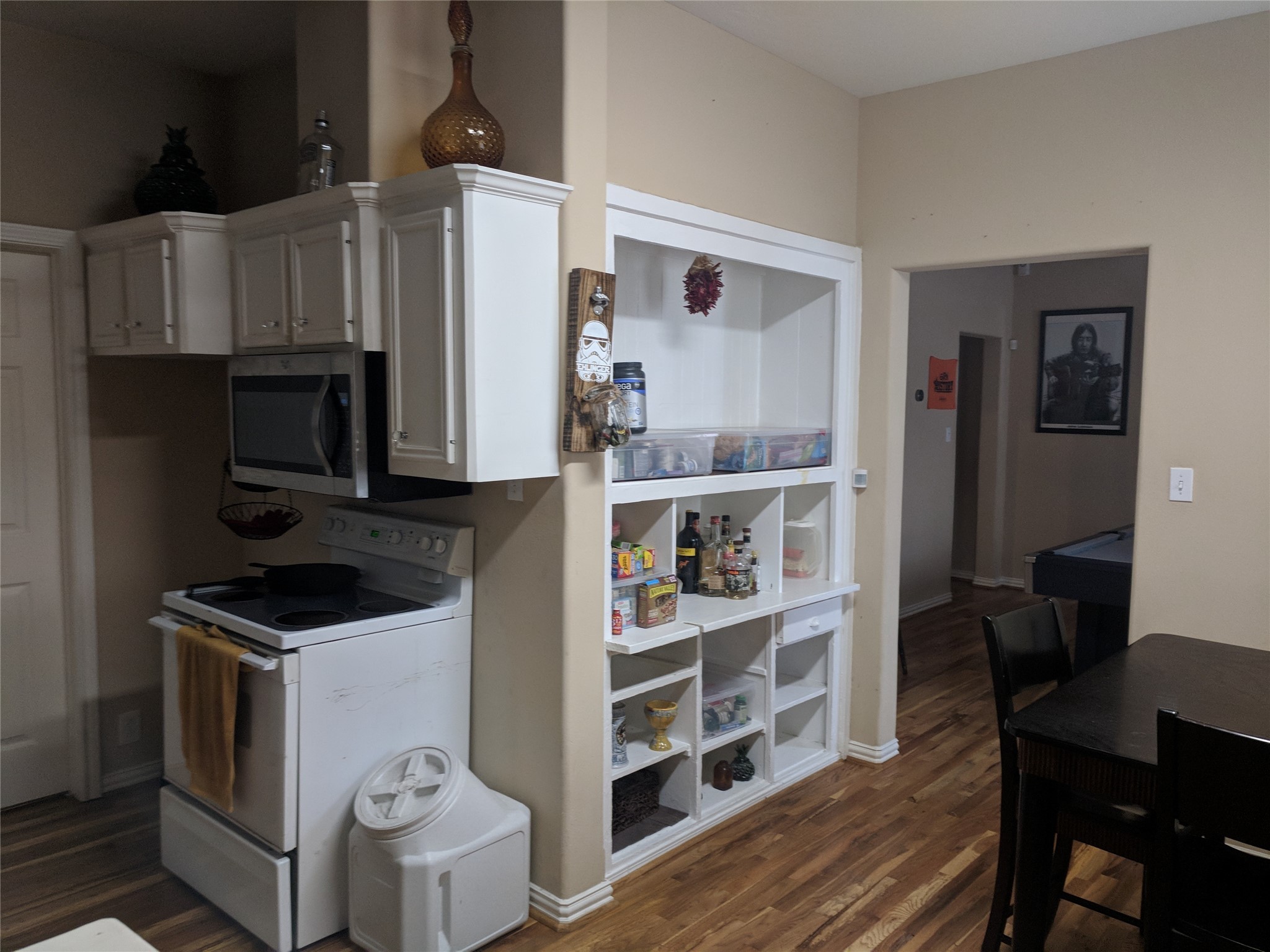 4615 Woodside Street Houston, TX 77023 - Photo 10 of 25 a kitchen with a cabinets and wooden floor
