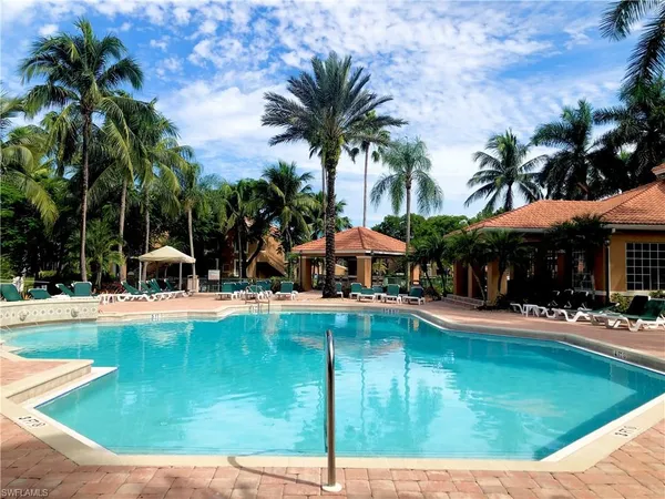 a swimming pool with outdoor seating yard and patio