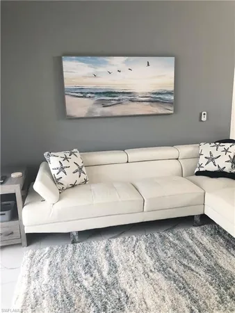 a living room with furniture and white wall