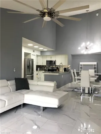 a living room with furniture and a chandelier