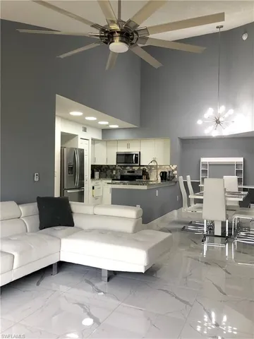 a living room with furniture and a chandelier