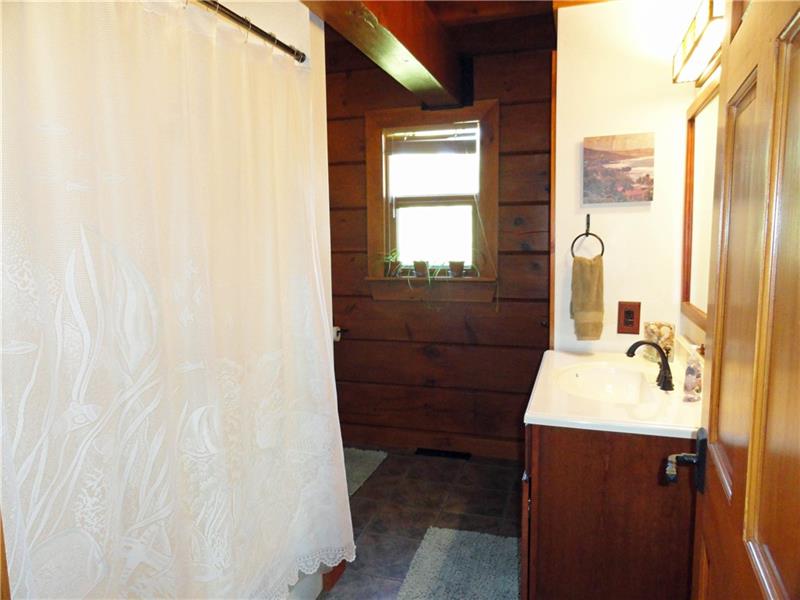 528 Dick Station Road Irwin, PA 15642 - Photo 12 of 25 Main bath with hickory vanity, tub with shower, ceramic floor and linen closet