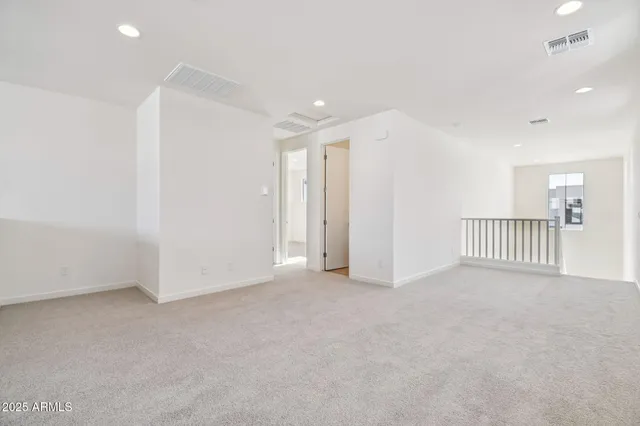 an empty room with a window and a ceiling fan