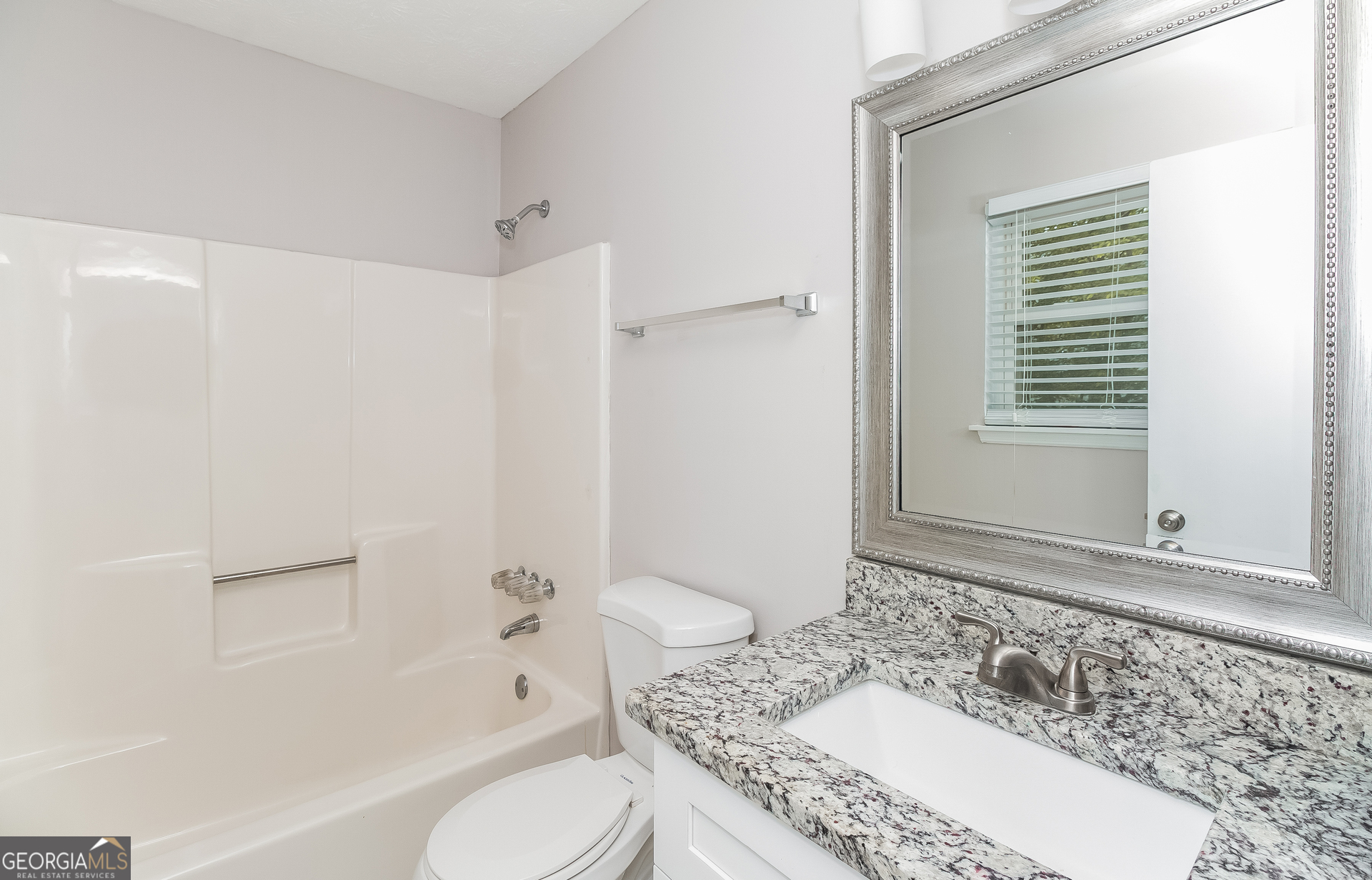 3020 Creel Road South Fulton, GA 30349 - Photo 14 of 18 a bathroom with a granite countertop tub sink and mirror