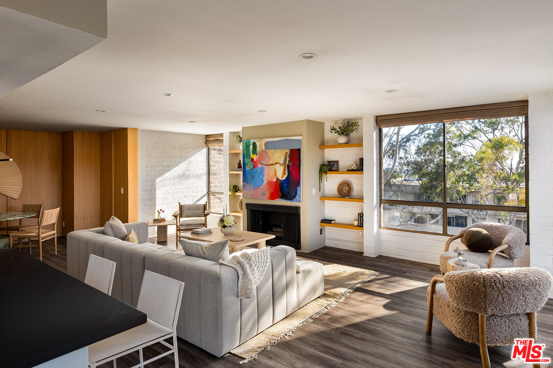2304 South Beverly Glen Boulevard, Unit 501 Los Angeles, CA 90064 - Photo 1 of 13 a living room with fireplace furniture and a large window