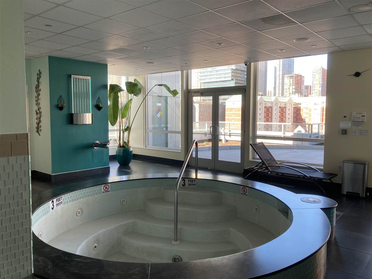 2 2nd Street, Unit 3304 Jersey City, NJ 07302 - Photo 16 of 25 a view of a swimming pool with a chair and front door