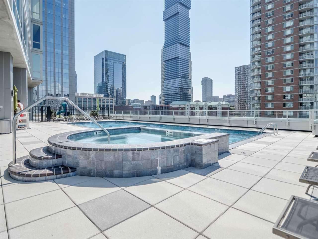 2 2nd Street, Unit 3304 Jersey City, NJ 07302 - Photo 23 of 25 a kitchen with a counter top a sink and a stove