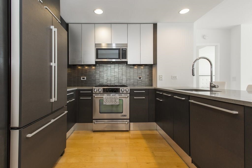 2 2nd Street, Unit 3304 Jersey City, NJ 07302 - Photo 6 of 25 a kitchen with a sink appliances and cabinets