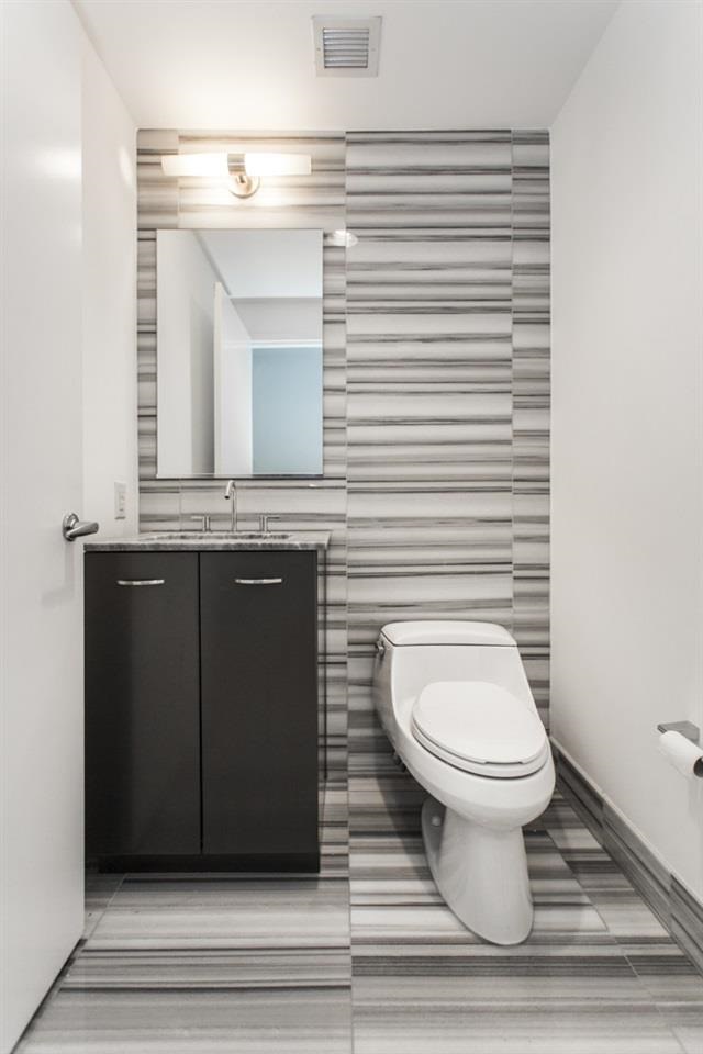 2 2nd Street, Unit 3304 Jersey City, NJ 07302 - Photo 8 of 25 a bathroom with a toilet and a mirror