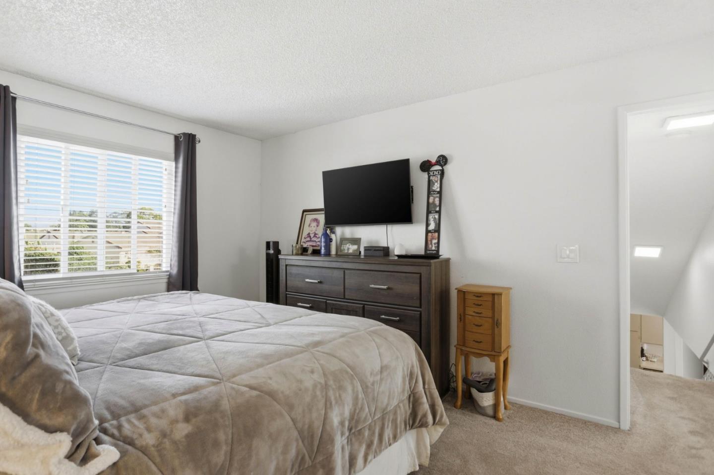 1075 Sherman Drive Salinas, CA 93907 - Photo 18 of 24 a bedroom with a bed and a flat screen tv