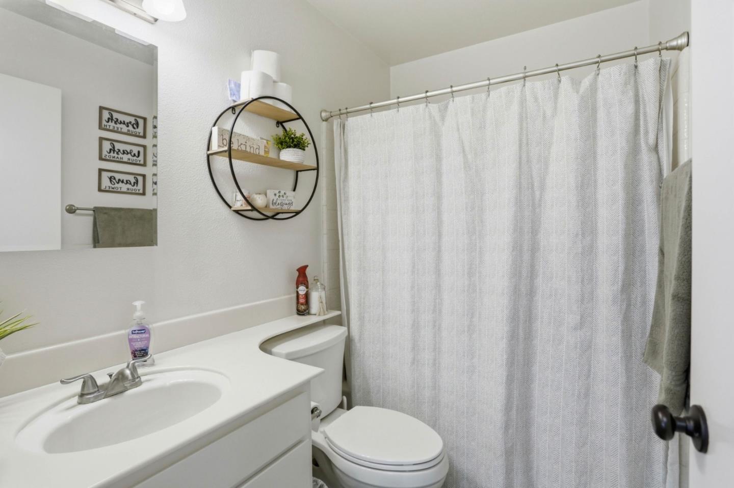1075 Sherman Drive Salinas, CA 93907 - Photo 19 of 24 a bathroom with a toilet a sink and a mirror