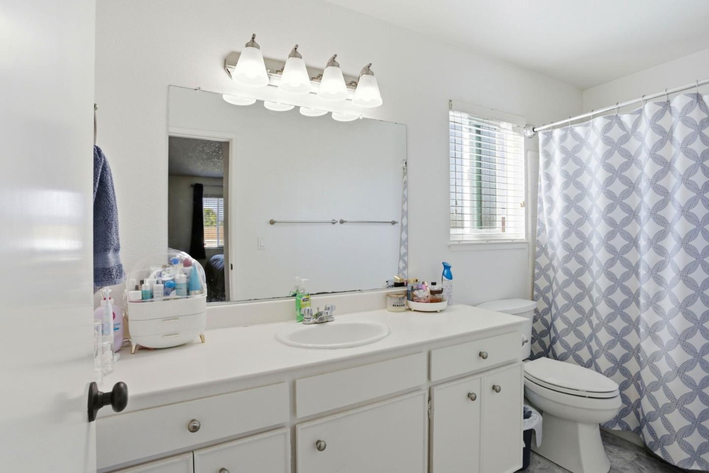 1075 Sherman Drive Salinas, CA 93907 - Photo 20 of 24 a bathroom with a sink a mirror and a toilet
