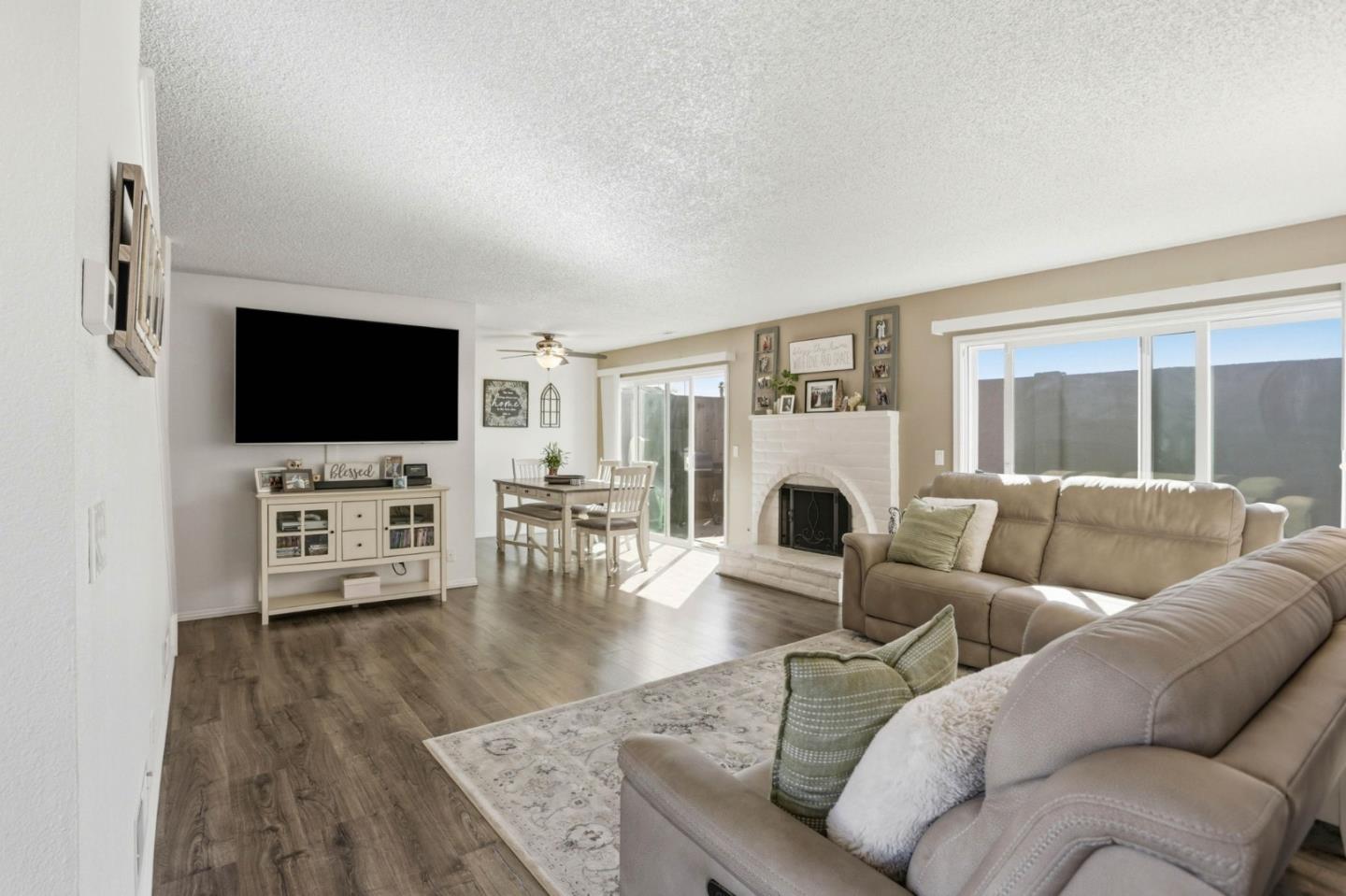 1075 Sherman Drive Salinas, CA 93907 - Photo 4 of 24 a living room with furniture a fireplace and a flat screen tv