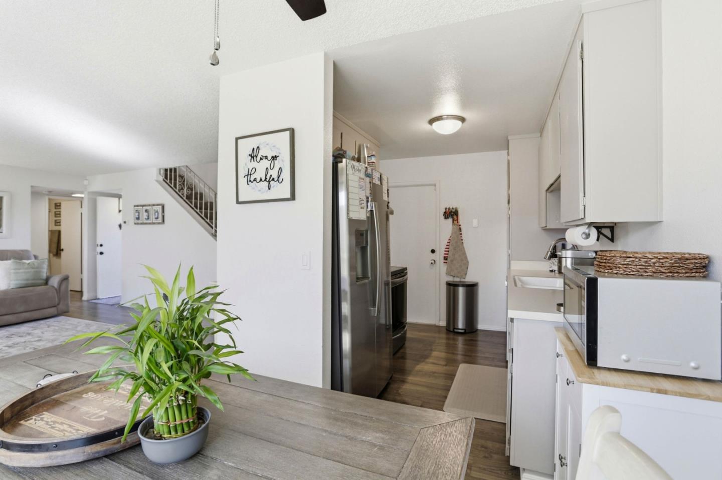 1075 Sherman Drive Salinas, CA 93907 - Photo 8 of 24 a kitchen with stainless steel appliances kitchen island a refrigerator and a couch