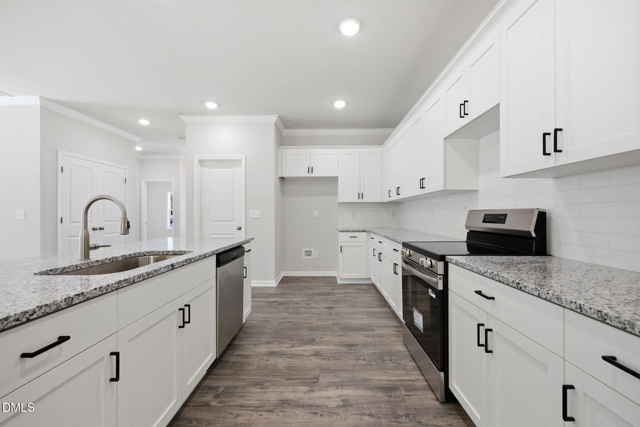 191 Nectar Lane Bunnlevel, NC 28323 - Photo 11 of 35 a large kitchen with stainless steel appliances granite countertop a lot of counter space and wooden floors