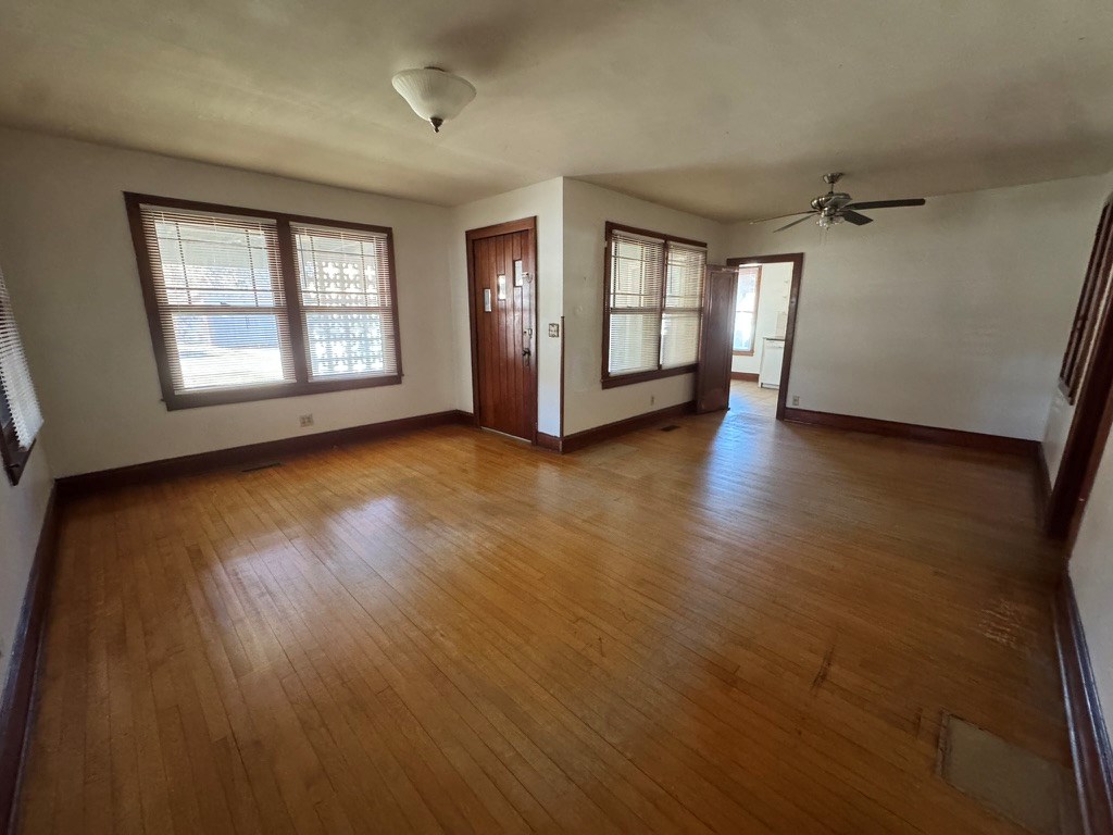 245 Blue Ridge Drive McCaysville, GA 30555 - Photo 4 of 20 an empty room with wooden floor and windows