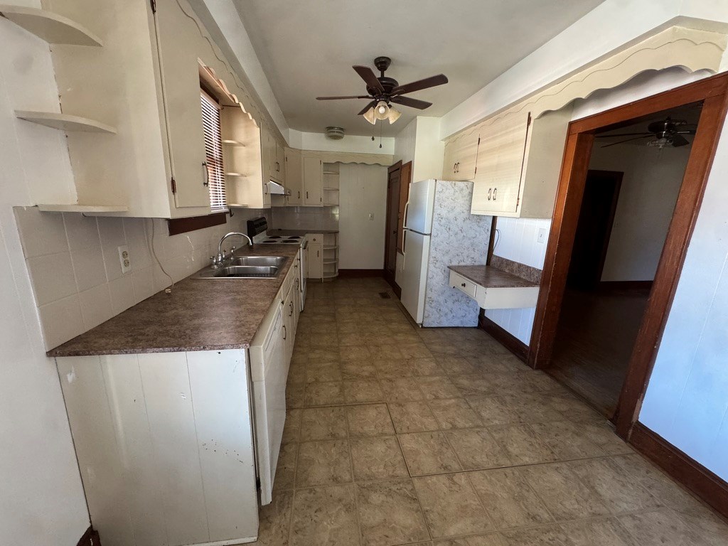 245 Blue Ridge Drive McCaysville, GA 30555 - Photo 10 of 20 a kitchen with a sink a refrigerator and cabinets