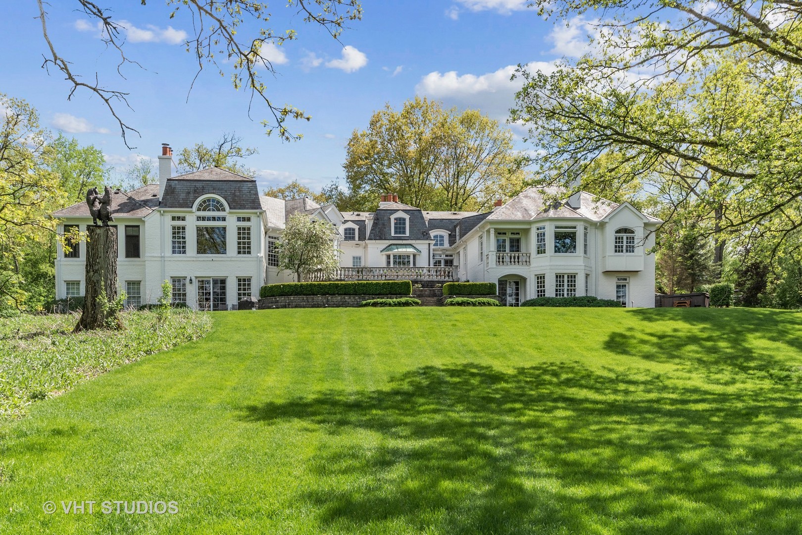 34 Oak Knoll Road Barrington Hills, IL 60010 - Photo 66 of 82 a front view of a house with a yard table and chairs