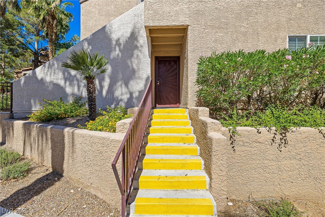 9325 West Desert Inn Road, Unit 104 Las Vegas, NV 89117 - Photo 2 of 25 View of exterior entry with stucco siding