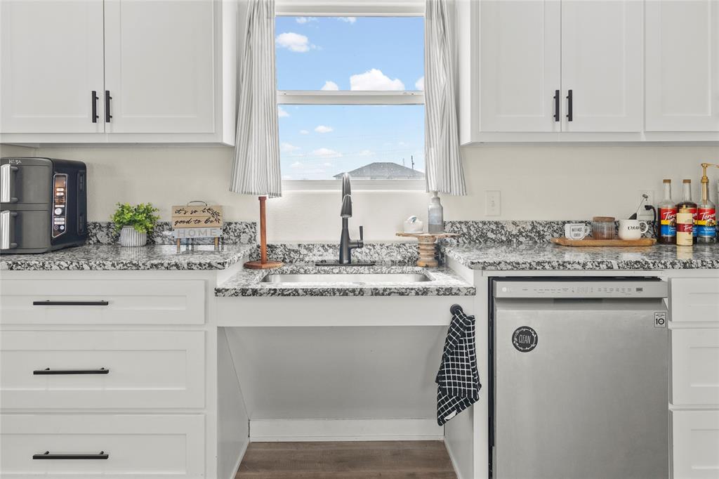 170 Private Road Brookston, TX 75421 - Photo 11 of 33 a kitchen with cabinets appliances a sink and a counter top space