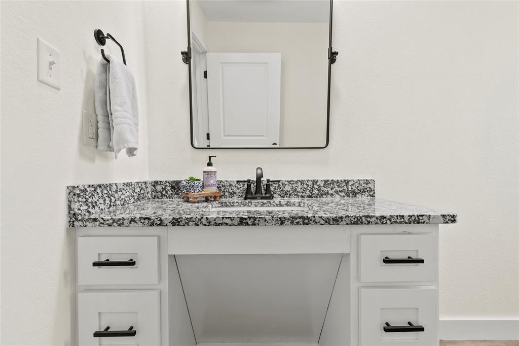 170 Private Road Brookston, TX 75421 - Photo 17 of 33 a bathroom with a granite countertop sink and a mirror