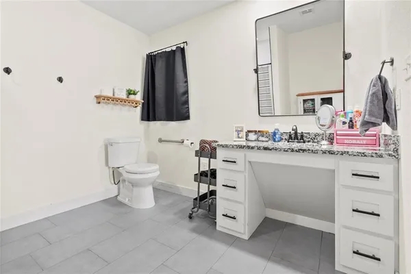 a bathroom with a sink toilet and mirror